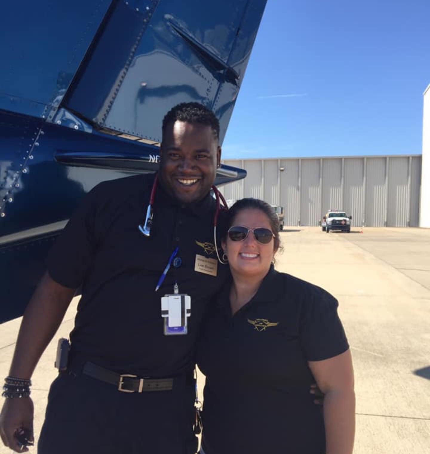 Lee Brown, flight paramedic, standing beside a medical transport aircraft